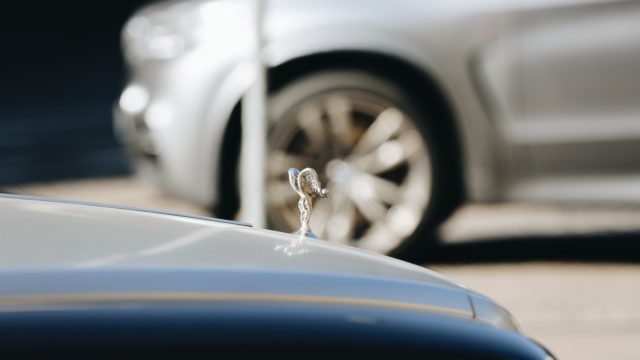 selective focus photography of silver-colored vehicle hood accessory
